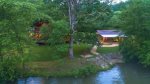 The River House: Aerial View of Cabin at Dusk